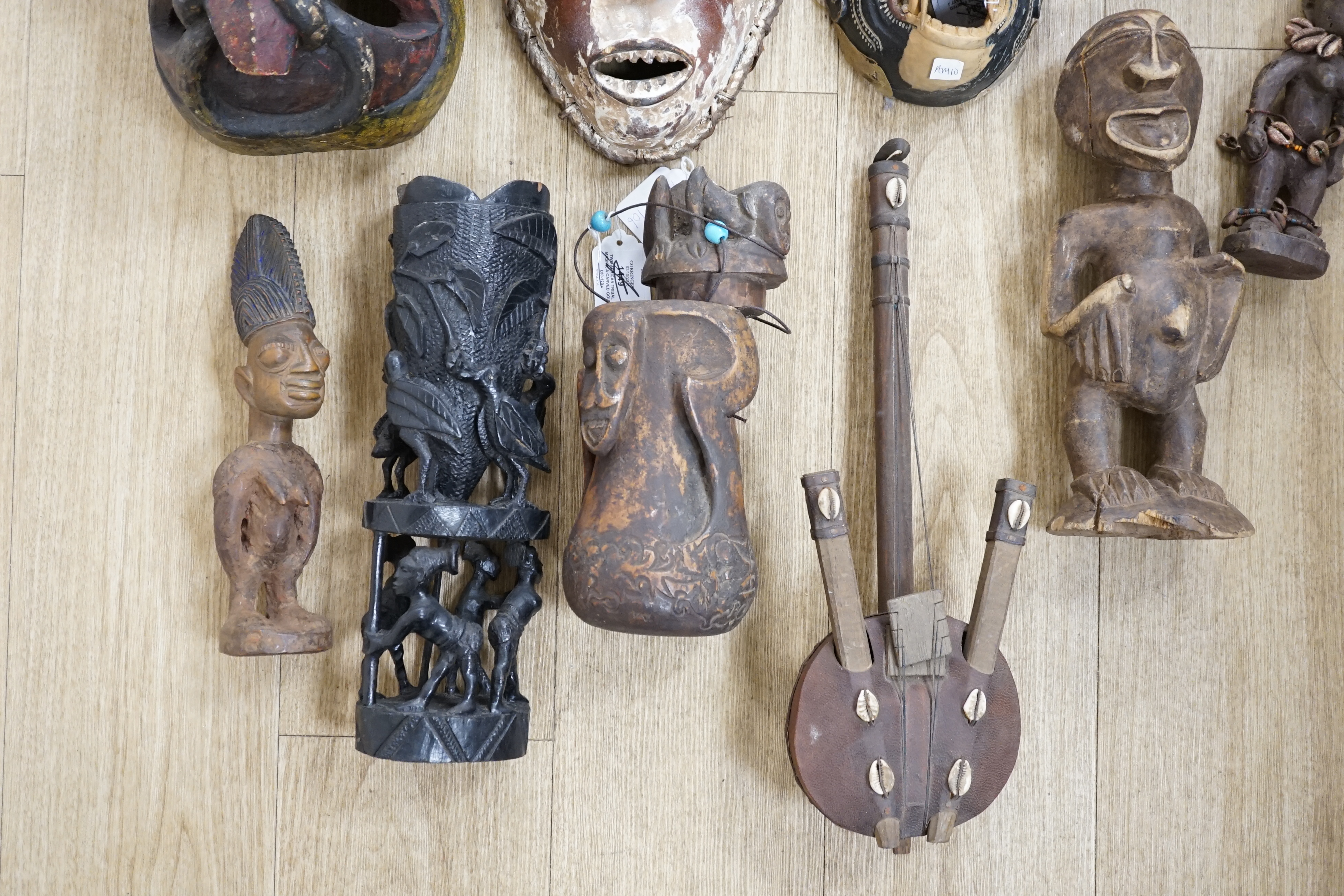 Eight Yoruba carved wood tribal figures and a terracotta vessel (9), largest 35cm high
